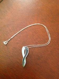 A denim cause ribbon, crafted after the Global Genes Project's slogan, "Hope it's in our Genes!"