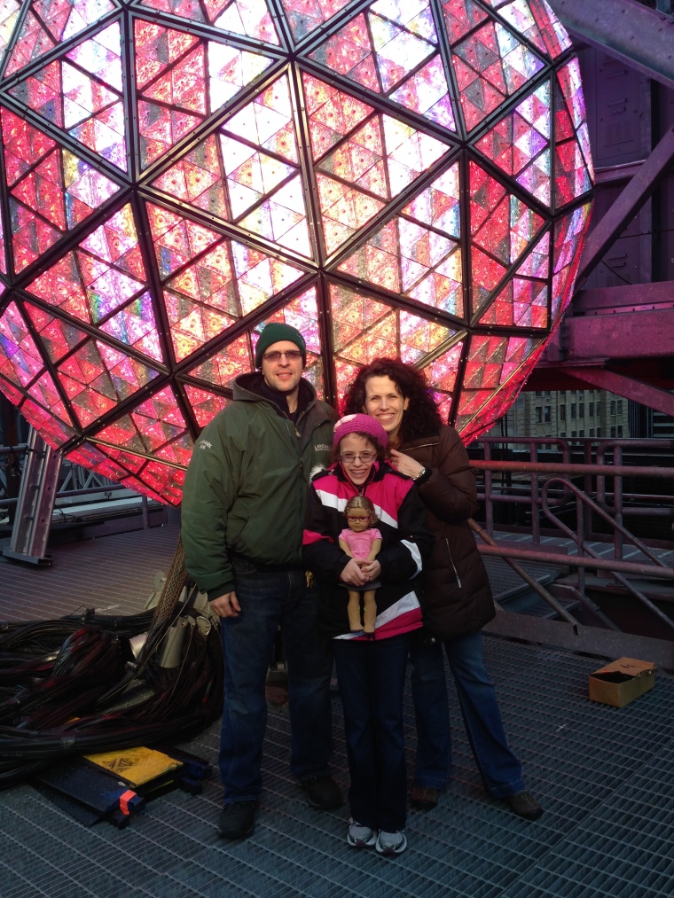 Family shot in front of the New Year's Eve Ball.